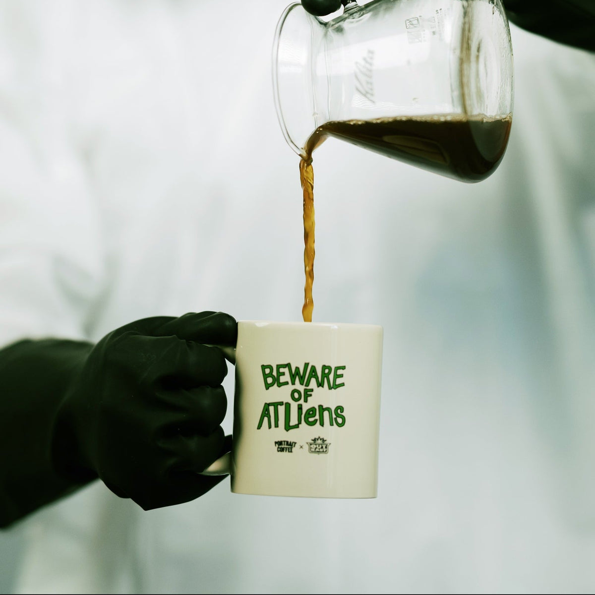 Pouring coffee into the Beware of ATLiens mug