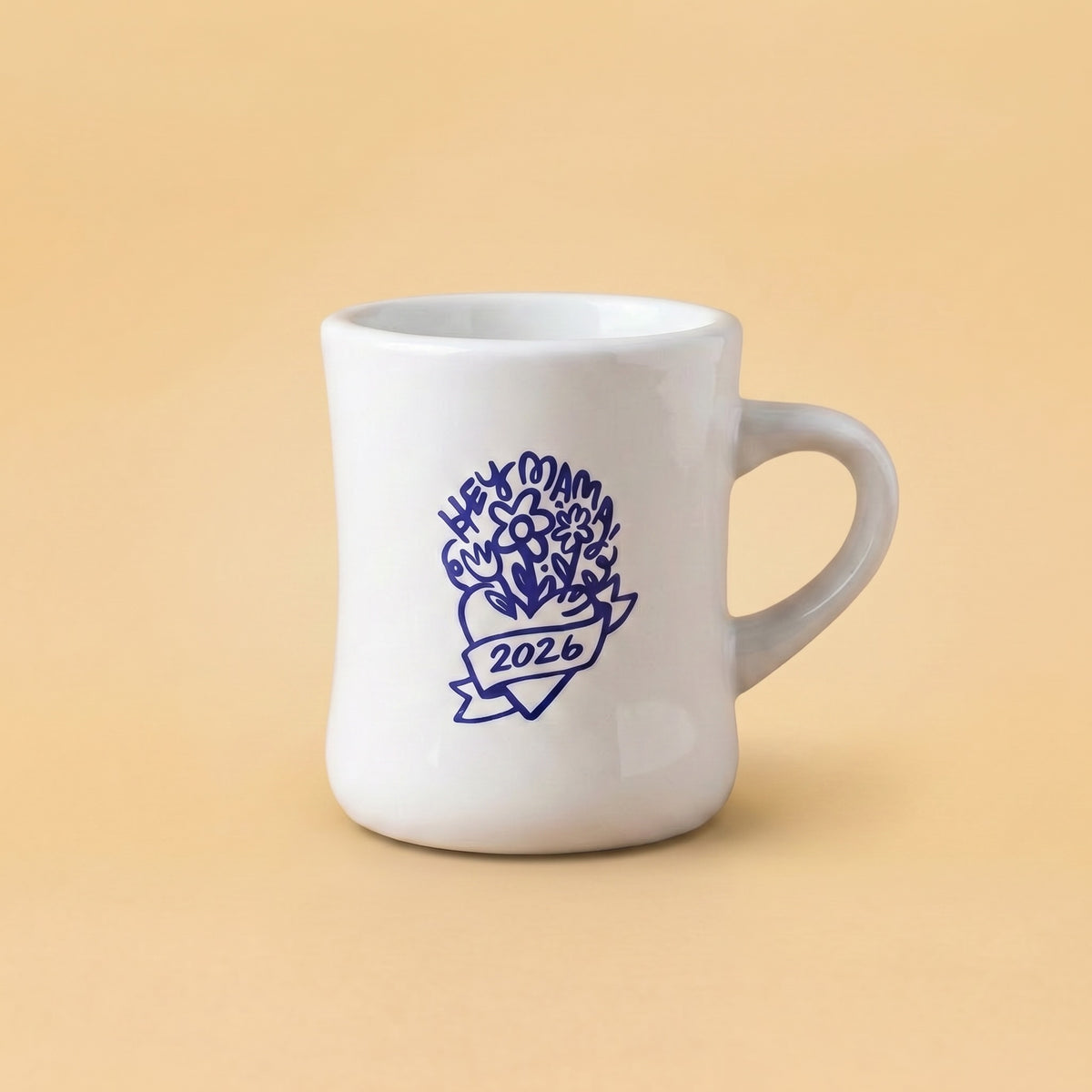 White mug with blue floral design and '2026' text on a beige background